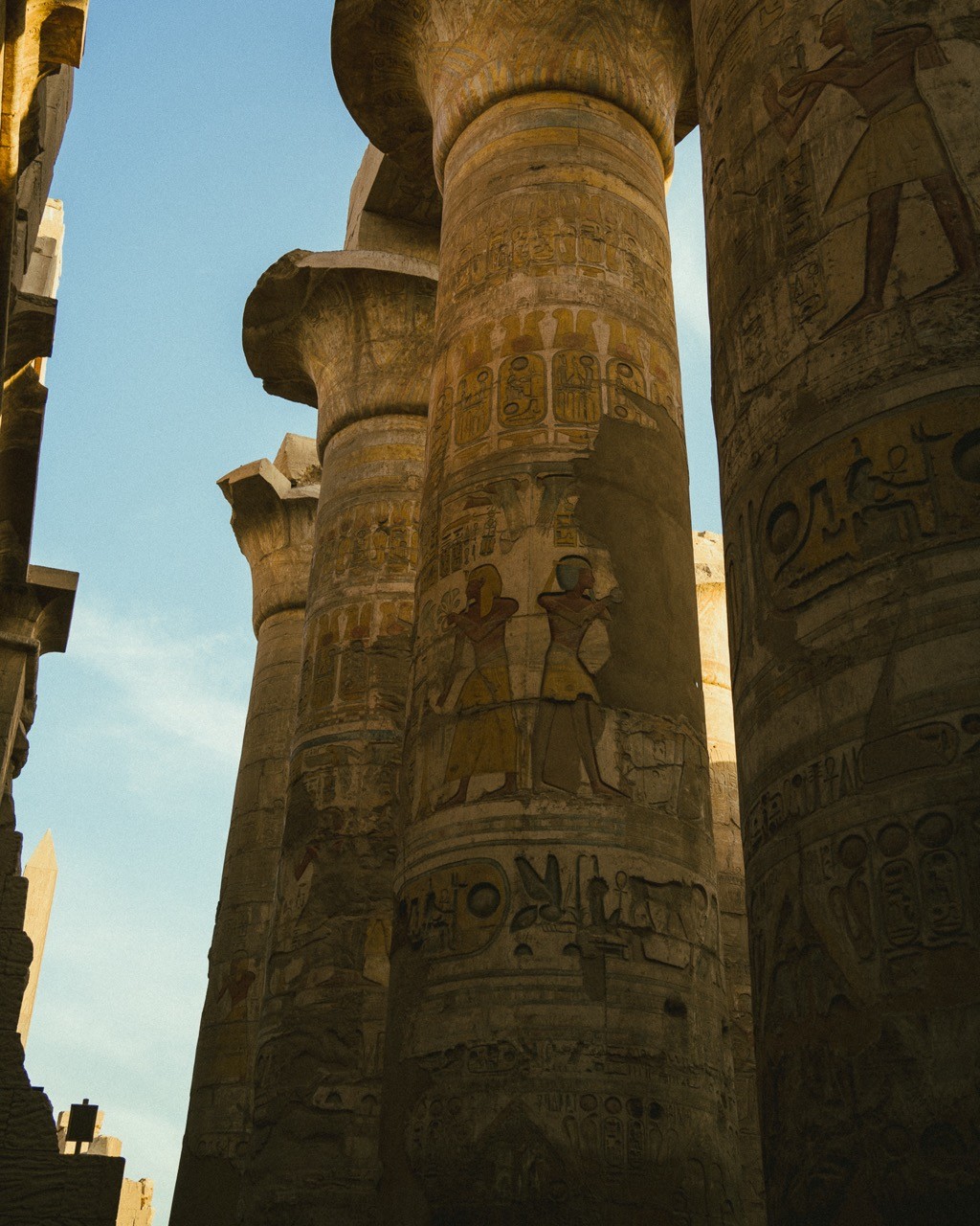 The great columns of the Karnak hypostyle hall, covered in detailed hieroglyphs.