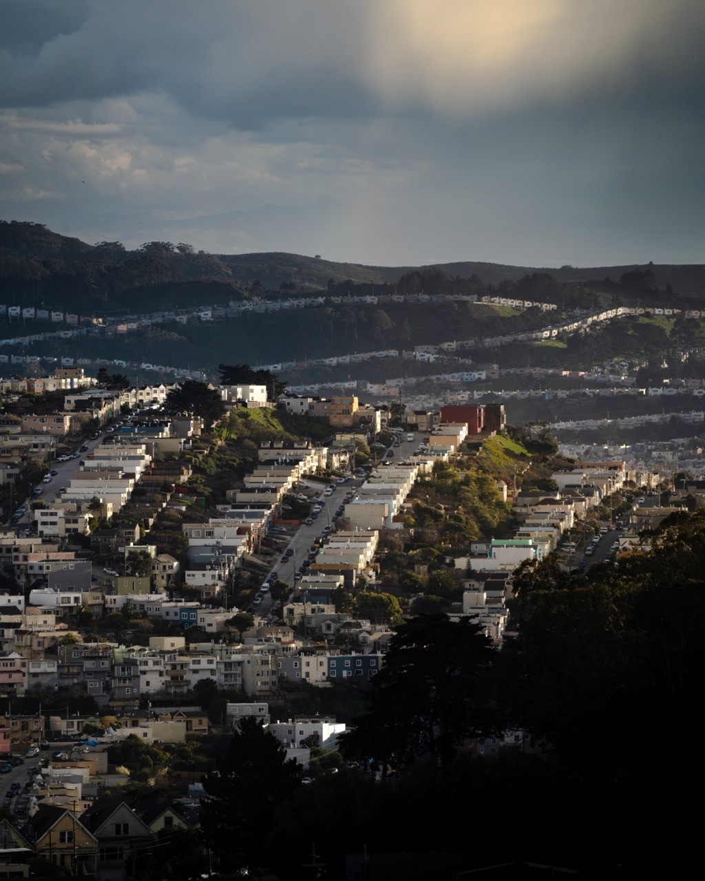 Rows of pastel homes draped over the hillsides of Daly City.